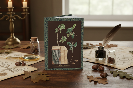 Oak Tree Journal on 18th-century naturalist table with pressed oak leaves, acorns, botanical manuscripts and magnifying glass - LeBonJournal