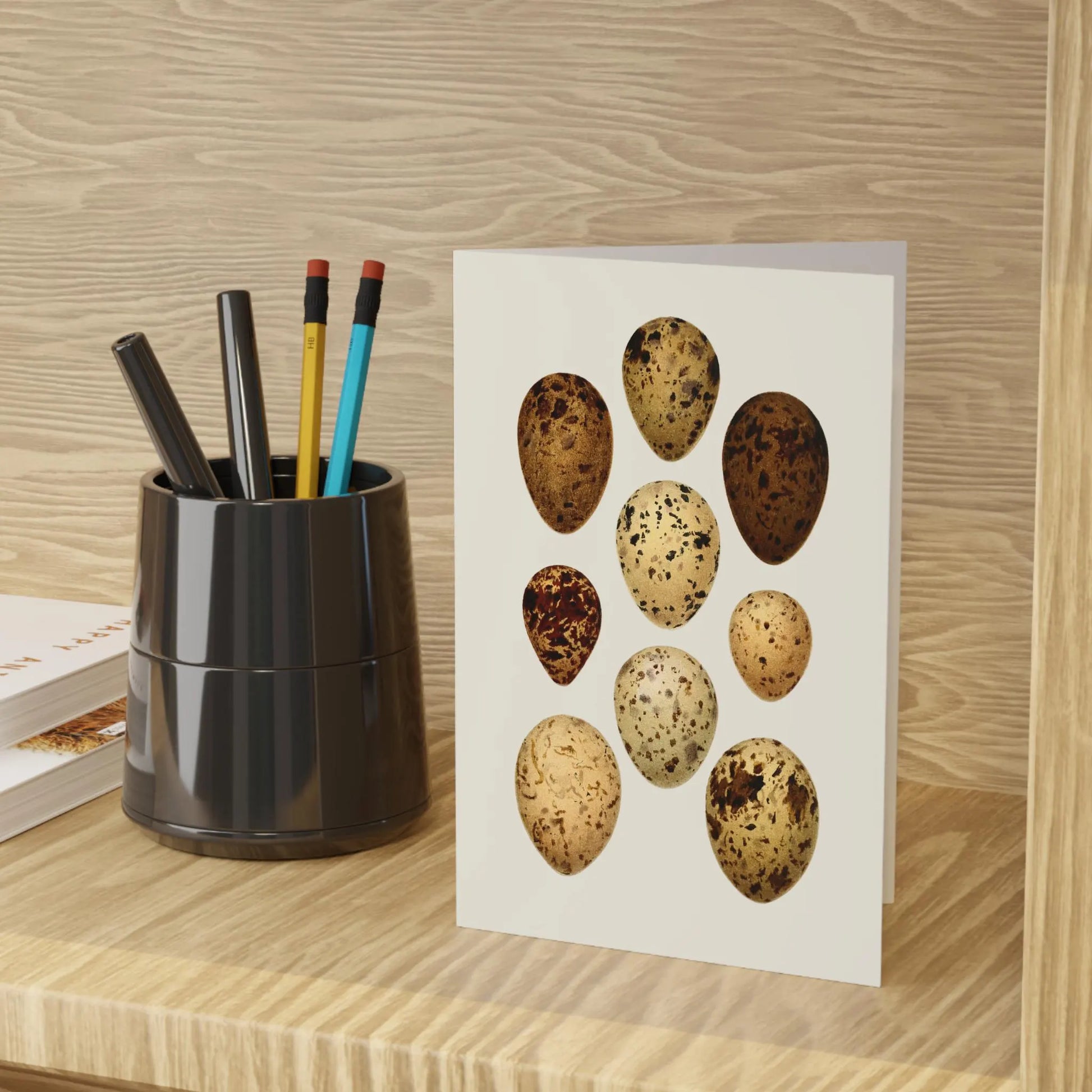 LeBonJournal botanical art notebook with illustrated bird eggs on a wooden desk