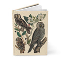 Hardcover wildlife journal standing upright showing front cover with Alexander Wilson's American owl illustrations from 1808, featuring Hawk Owl, Great Gray Owl, and Little Owl with dogwood flowers on matte finish cover - LeBonJournal
