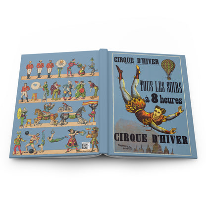 Open Cirque D'Hiver journal showing durable casewrap binding, hardcover construction with 1890 Paris circus poster and Paluzíe recortables on front and back covers, and flexible spine for lay-flat writing - LeBonJournal