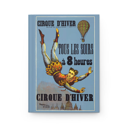 Front cover of Cirque D'Hiver journal featuring 1890 Paris Winter Circus poster with aerial acrobat, hot-air balloon, and Belle Époque Parisian skyline on premium matte hardcover - LeBonJournal