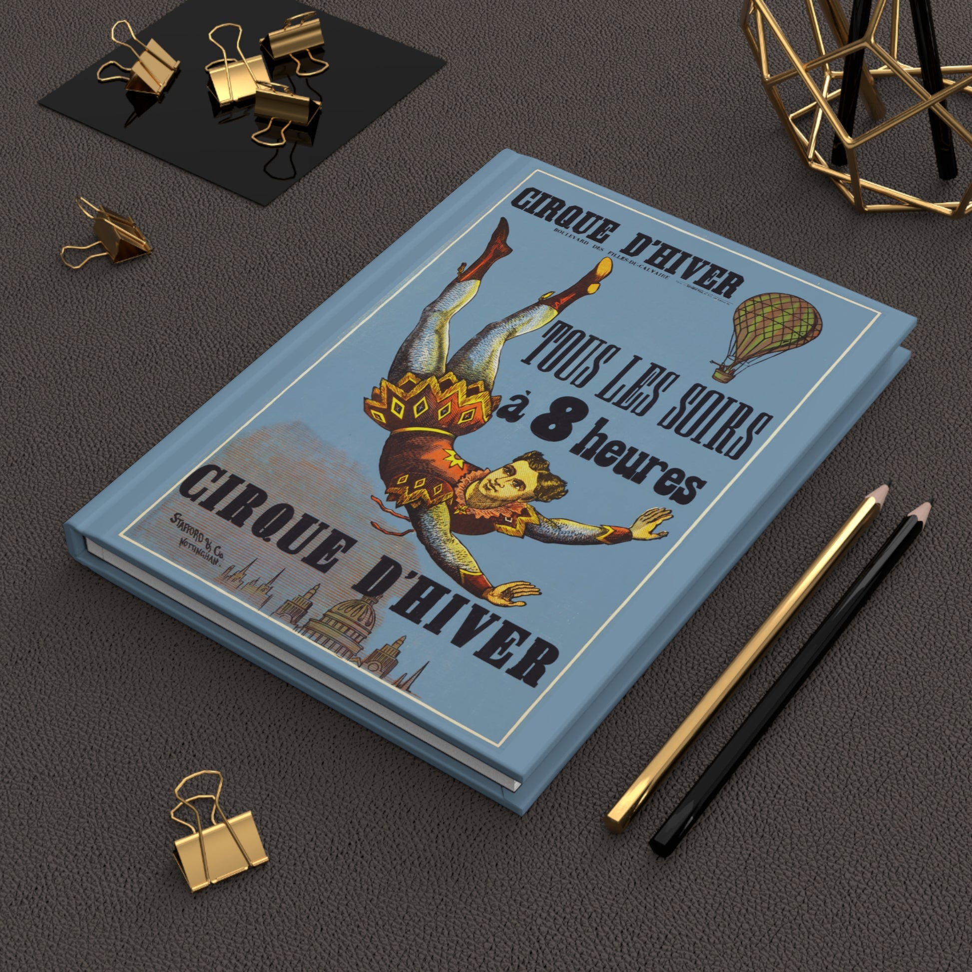 Cirque D'Hiver hardcover journal in lifestyle setting, premium matte finish journal featuring vintage Paris circus poster, elegant stationery for circus enthusiasts, Paris lovers, and Belle Époque admirers - LeBonJournal