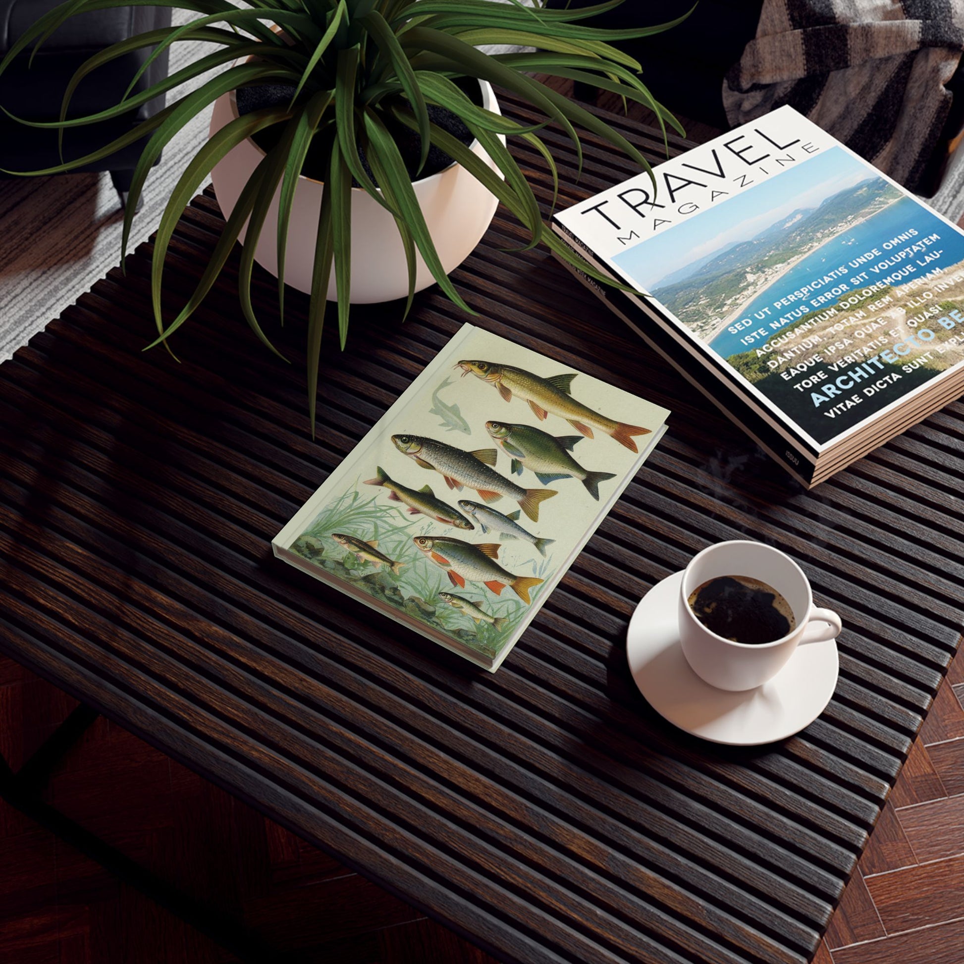 Freshwater fish journal on wooden desk with travel magazine and coffee cup - LeBonJournal