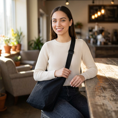 Young woman wearing solid black crossbody bag 16x16 inches with adjustable strap - LeBonJournal