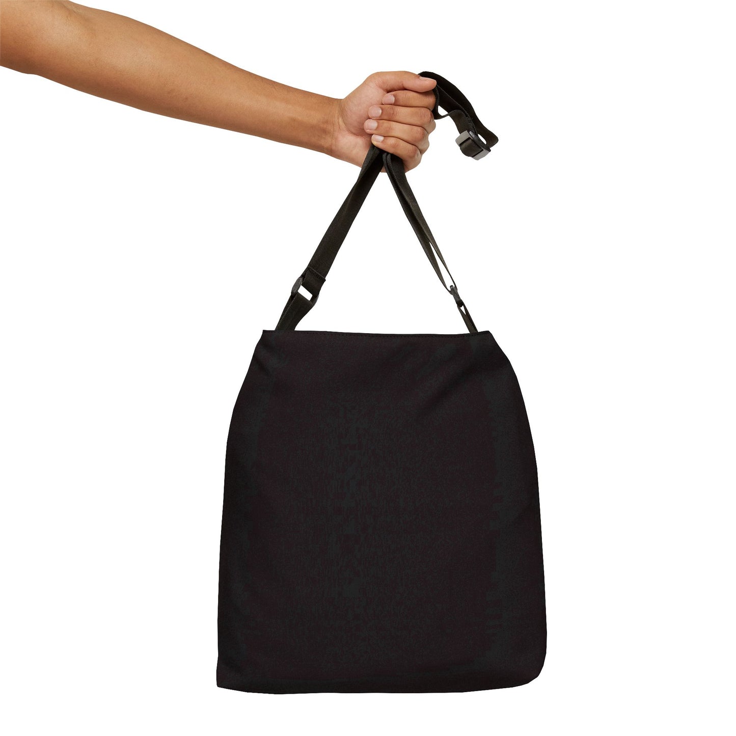 Hand holding solid black crossbody bag by single adjustable strap, minimalist everyday design - LeBonJournal