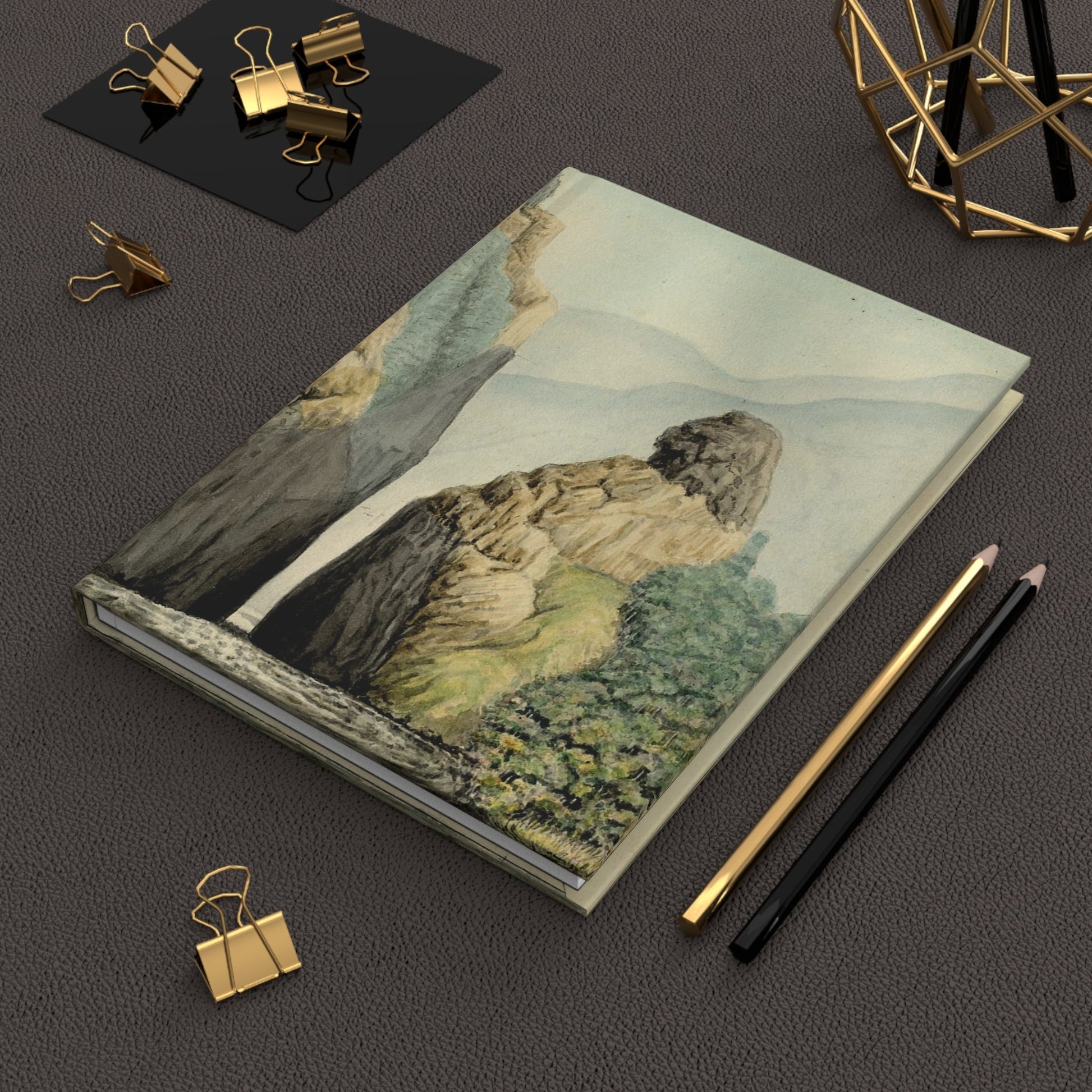 Carmelo Fernández 1850 Furatena Strait journal on desk with gold clips for travel notes - LeBonJournal
