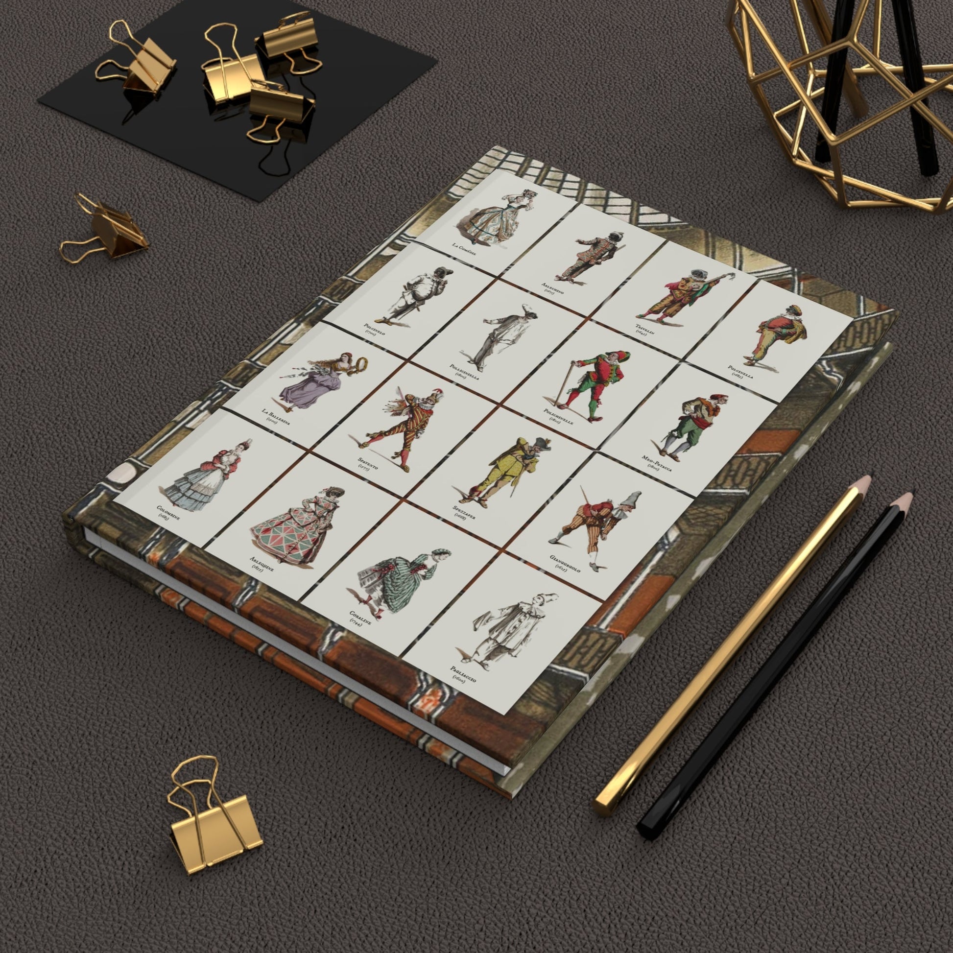 Maurice Sand Commedia dell'Arte journal on desk with gold clips for theatrical notes - LeBonJournal