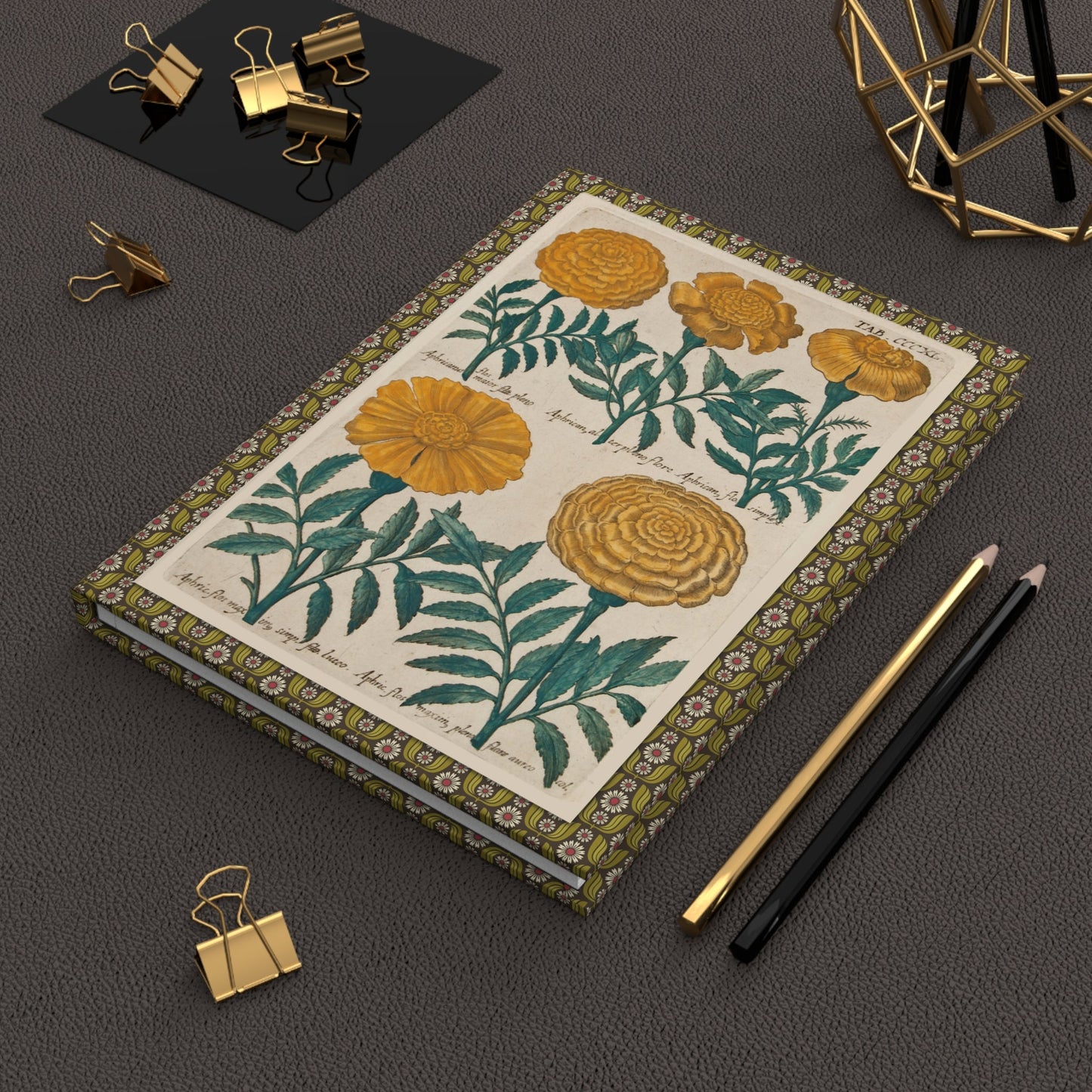 Emanuel Sweert 1612 marigold journal on desk with gold clips for garden notes - LeBonJournal