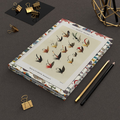 Mary Orvis Marbury 1892 trout flies journal on desk with gold clips for fishing logs . LeBonJournal