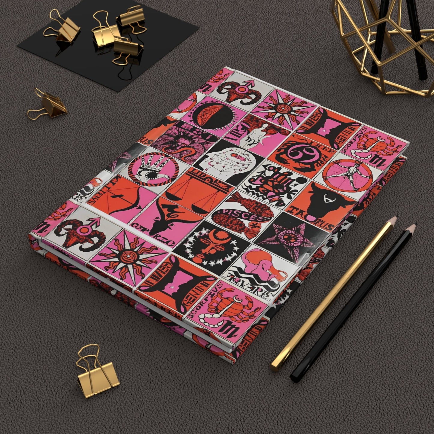 Psychedelic zodiac journal on desk with gold clips for astrology journaling - LeBonJournal