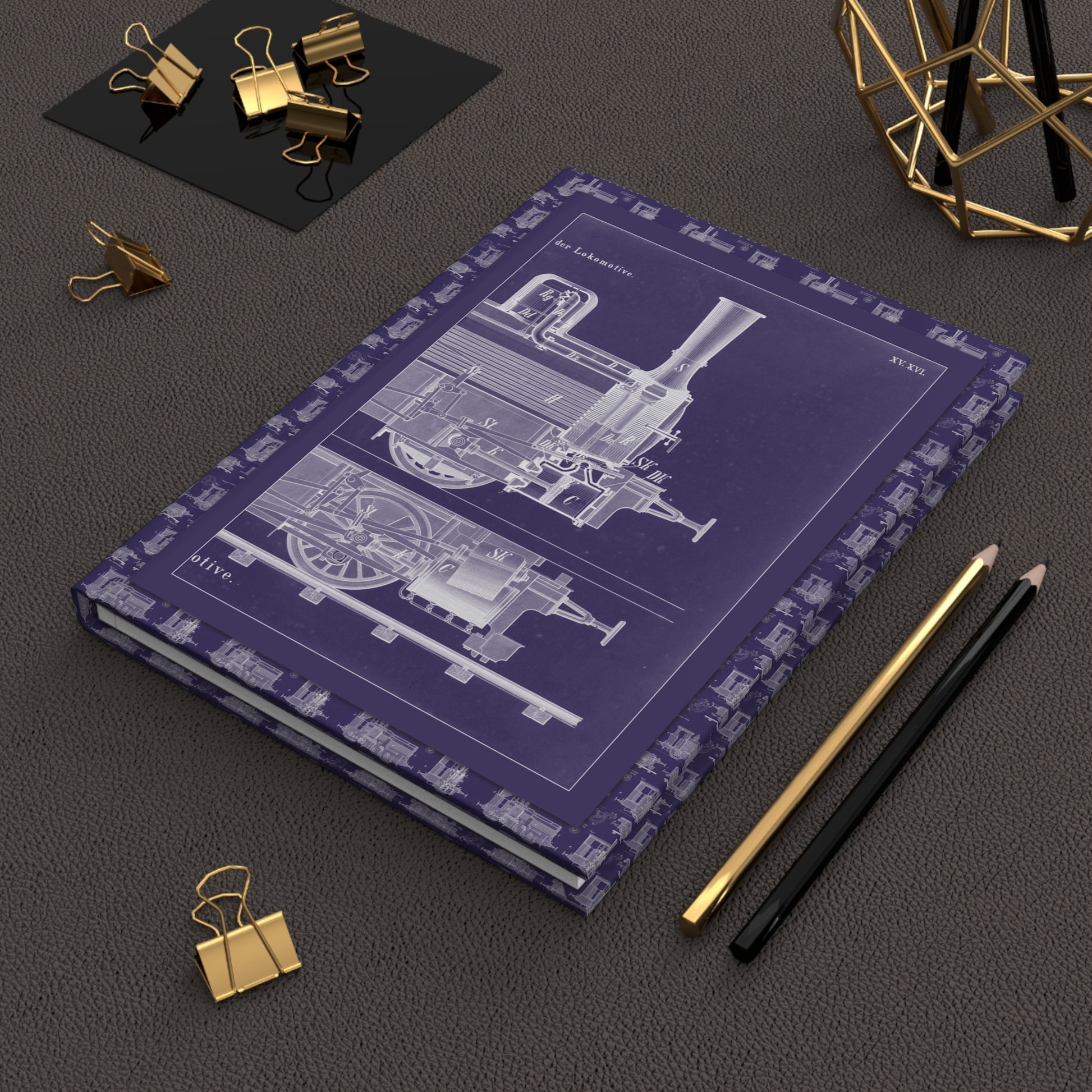 R. Menzel 1908 locomotive blueprint journal on desk with gold clips for engineering notes - LeBonJournal