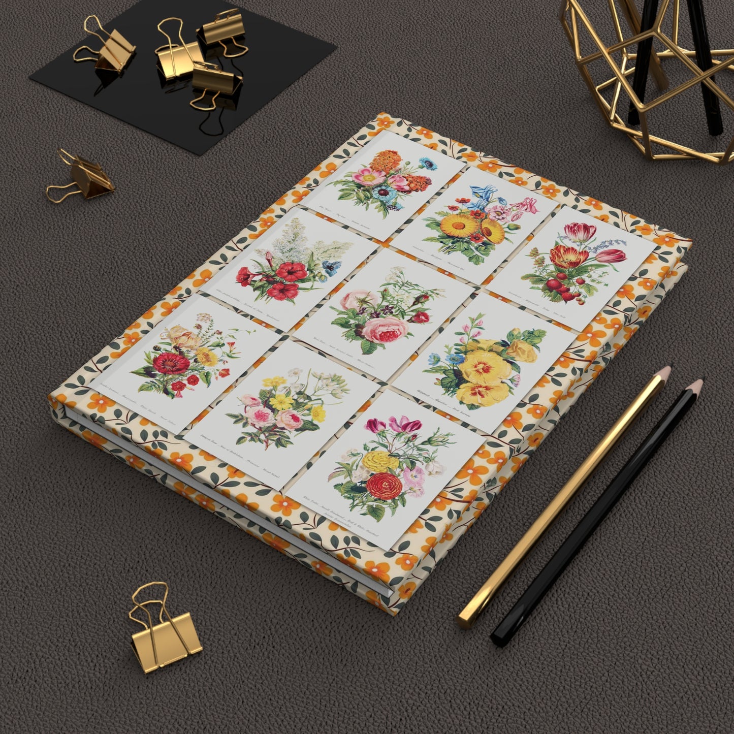 Robert Tyas floral journal on desk with gold clips for botanical journaling - LeBonJournal