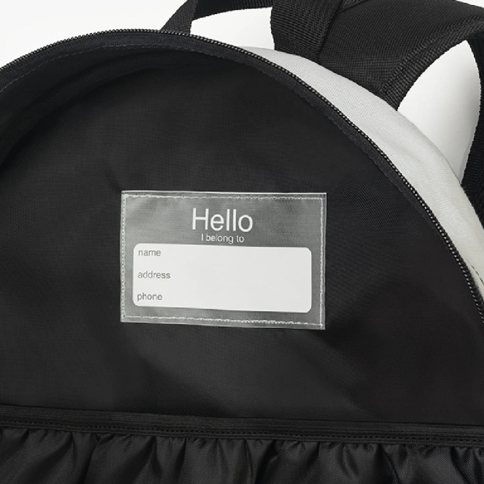 Interior Compartment With Customizable Label Close-up of the spacious interior lining and custom branding label inside the Classic Black Backpack.