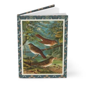 Slightly open hardcover European songbirds journal showing smooth lined pages and 19th-century Naumann botanical cover artwork.